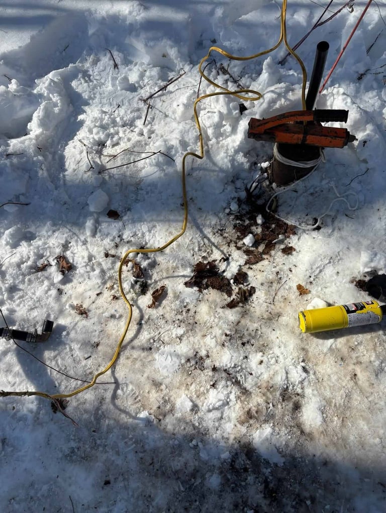 Overhead view of disassembled drone wreckage scattered on snow with tangled wires and broken components